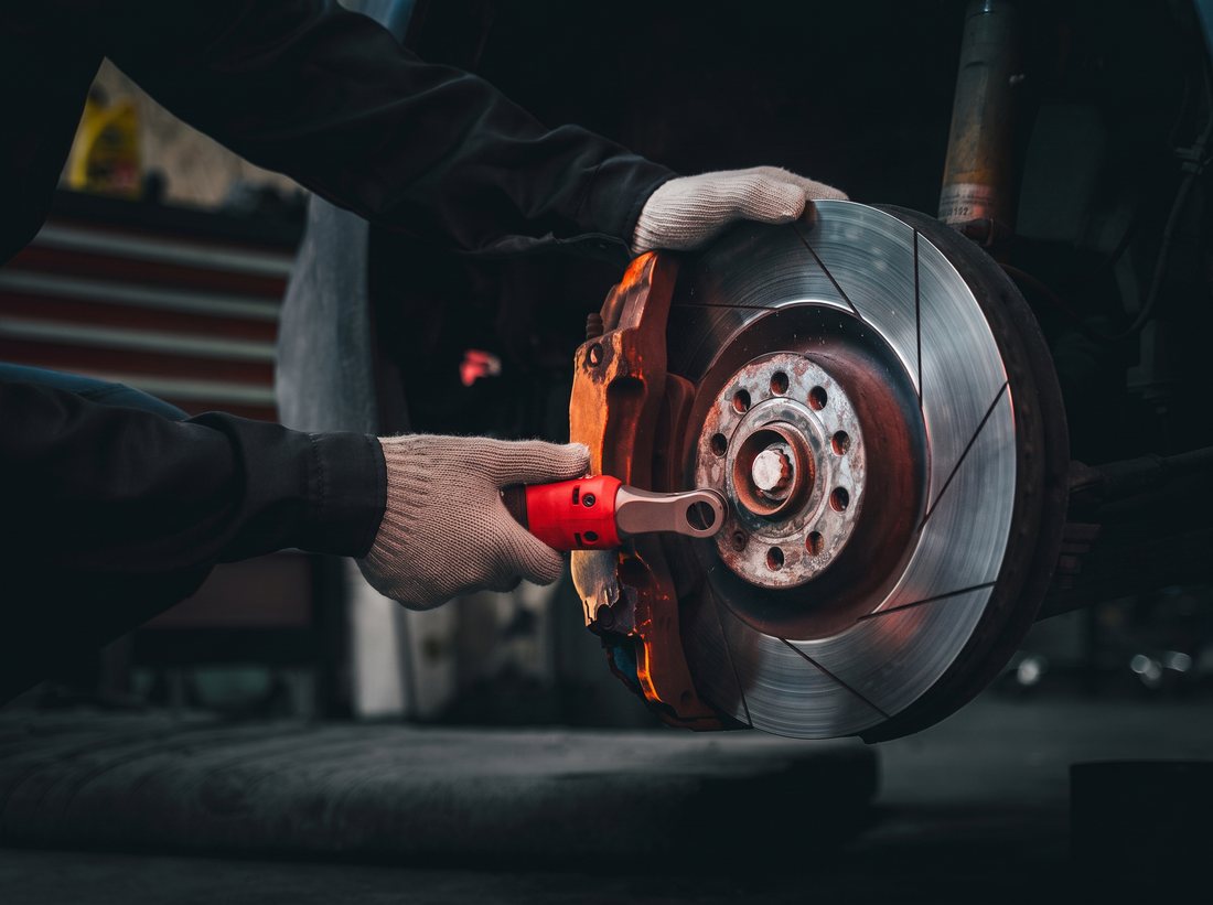 Brake disc and caliper being serviced
