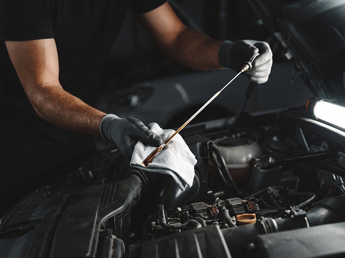 Engine oil level being checked on a dipstick